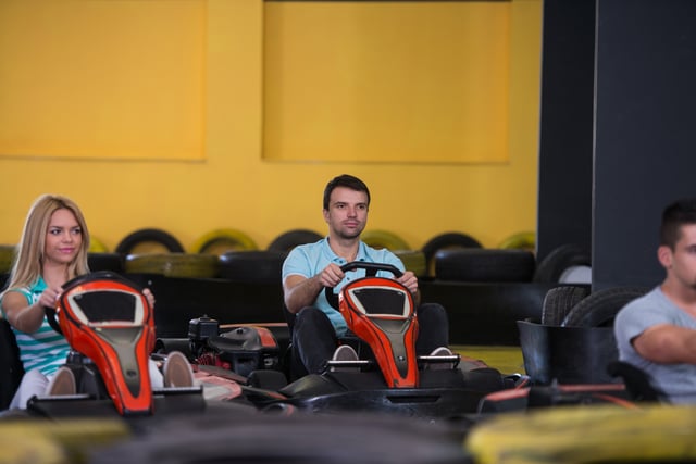 People Driving Go Karts On Track